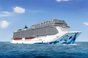 Image of Norwegian Bliss cruise ship featuring the colourful base with clear blue skies and waters.
