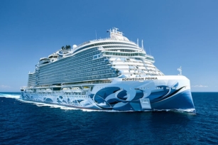 Image of the front of the Norwegian Prima cruise ship cruising through the deep blue waters